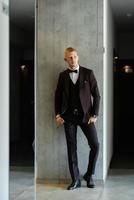 portrait of the groom in a brown three-piece suit photo