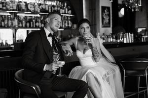 bride and groom inside a cocktail bar photo