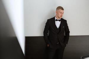 portrait of the groom in a brown three-piece suit photo