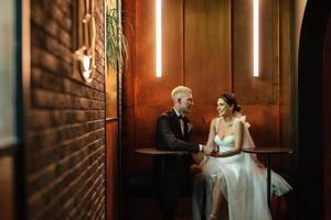 bride and groom inside a cocktail bar photo