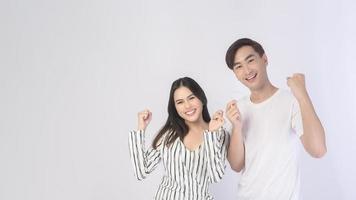 Young smiling man amd woman holding invisalign braces over white background studio, dental healthcare and Orthodontic concept. photo