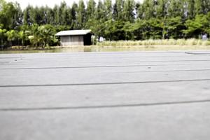 The floorboard with only emptiness overlooking the hut at the end of the rice field and the beautiful and empty nature. photo