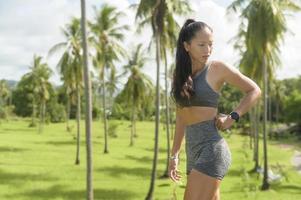 Portrait of Beautiful fit woman wearing sportswear in tropical park, Health and sport concept. photo