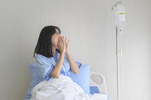 Hopeful and happy young patient woman in hospital, healthcare and medical concept photo