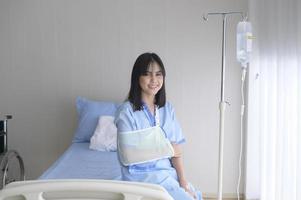 Hopeful and happy young patient woman in hospital, healthcare and medical concept photo