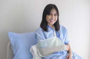 Hopeful and happy young patient woman in hospital, healthcare and medical concept photo