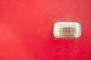 Car turn signal lights - doors - old classic red cars being repaired and recycled. photo