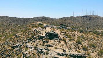 Zooming out of visitor's stop Dobbins Lookout on South Mountain, Phoenix, Arizona. Aerial view of Dobbins Lookout observation tower, with magnificent view of valley, copy space. Concept of landscape video