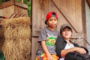 Mother and daughter in the garden have a photo corner with a straw in the background - Suan Phueng, Ratchaburi -2014