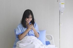 A despondent Asian woman patient. Following the doctor's declaration that the cancer was nearing the end of its course. photo