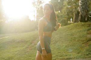 Portrait of Beautiful fit woman wearing sportswear in park, Health and sport concept. photo