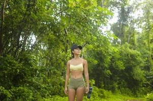 Beautiful asian woman in sportswear trekking on mountain trail, Travel and ecotourism concept. photo