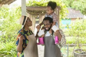 Happy black agronomist family enjoying and working in farmland, agriculture concept photo