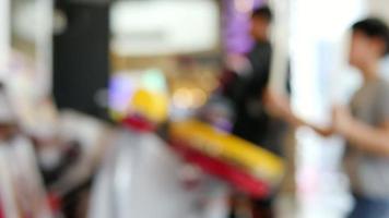 Children playing arcade game in toy land - blur background fun play land in the indoor arcade game city recreation concept video