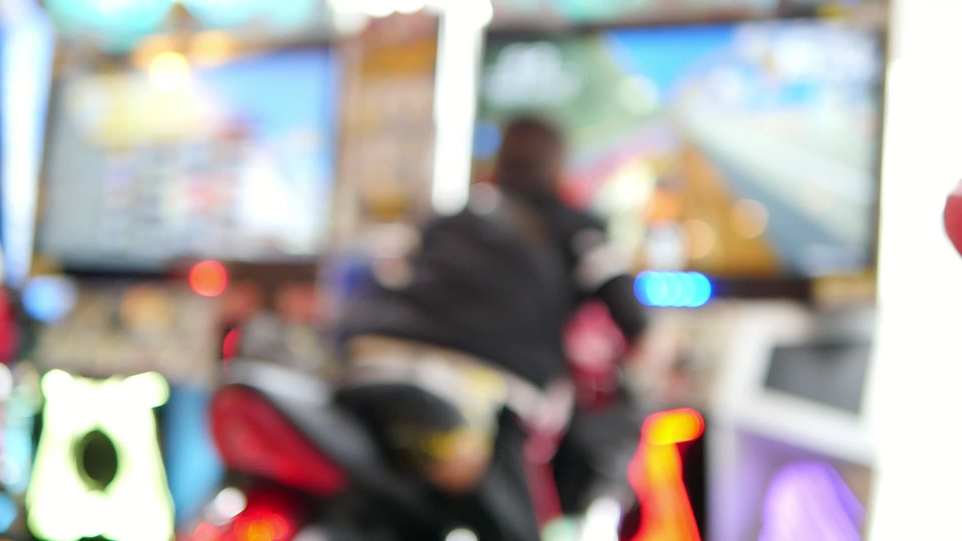 Children playing arcade game in toy land blur background fun play