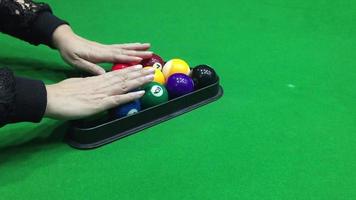 Lady setting up the pool ball for begin the game - people in pool snooker indoor sport concept video