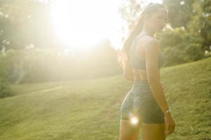 Portrait of Beautiful fit woman wearing sportswear in park, Health and sport concept. photo