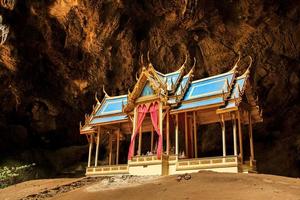 An ornate Thai pavilion built by skilled artisans located in one of Thailand's caves is a Thai pavilion that is hundreds of years old but is still in perfect condition. photo