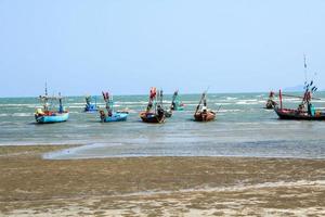 small fishing boat that catches fish and squid along the coast in a traditional way and maintains a fish and marine ecosystem for a long time on windy days photo