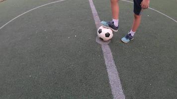 Boy is playing soccer football in green field - people with outdoor sport winner goal target success concept video