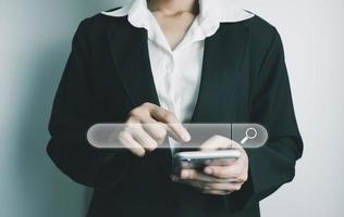 Search Engine optimization SEO concept, Businesswoman is using smartphone to search for information on Internet, Using the search bar, Wireless Network, big data and accessing website information. photo