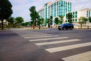 Crosswalk on the road for safety when people walking cross the street, Pedestrian crossing on a repaired asphalt road, Crosswalk on the street for safety, logistic import export and transport industry photo