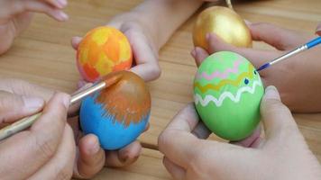 People painting colorful Easter eggs - Easter holiday celebration concept video