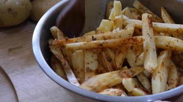 Lady mix sliced fresh potato with ingredient prepare for toast potato video