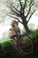 Happy asian seniors biking in the park photo