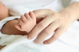 Closeup baby's hand with her mom, Healthy with mother for new family concept photo