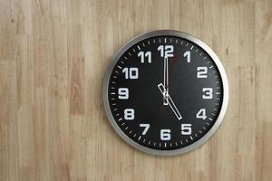 Standless Clock at 5 O'Clock, Finish work at 5 PM. Isolate on wooden Background, photo