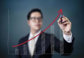 Businessman hand writing graph of growth, new business concept, studio shot photo