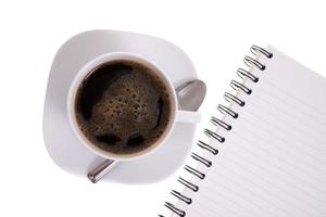 cup of coffee with notebook lined papers isolated on white photo