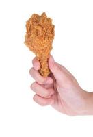 Hand hold fried chicken isolated on white photo