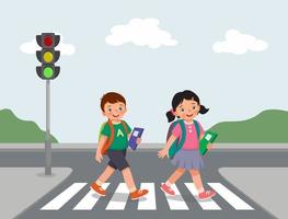 Cute School kids with backpack walking crossing road near traffic light on zebra crossing on the way to school