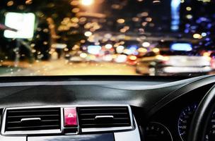 Front view of car looking out from inside with rain drop during twilight road background photo