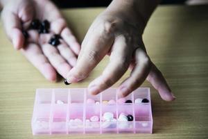 Woman prepare to eat periodical daily medicine pill - people healthcare with medicine pills concept photo