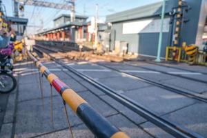 local japanese railroad tracks with home and car parking beside photo