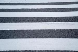 white line paint pattern on asphalt crosswalk in Japan. photo