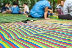 Asian mat on the grass ground in the outdoor park with blur people. photo