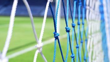 Behind the ropes of the outdoor soccer field goal net, Background for use in video production