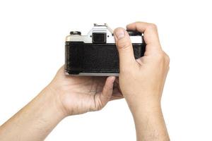 Man holding film camera ready to take photo over white background