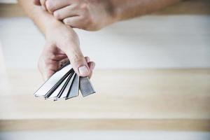 Carpenter holding air nailer for air nail gun doing wooden furniture work photo