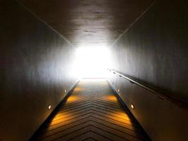 walk way and hand holder beside forward to the light exit or light of hope. photo