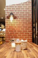 Take away Latte with Brick background on the wood table photo