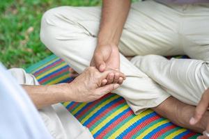 hand holds together in the community in the garden park. photo