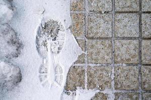 footprint in snow with half side tile in image in Japan. photo