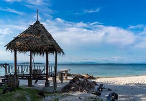 Pavilion made form leaf in vintage and island style settle on the beach with the sea, open sky background, Munnok Island, Thailand. photo