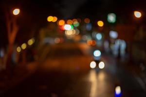 Abstract night bokeh from Thailand midnight street in dark and orange red tungsten mood and tone theme. photo