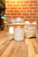 Take away Latte with Brick background on the wood table photo